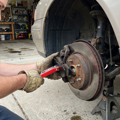 Pressing brake caliper pistons back with the Savary press on a car